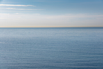 Blue calm sea, ocean and soft sky background. Selective focus. Copy space. Beautiful seascape panorama, nature composition. Feeling calm, relaxing.