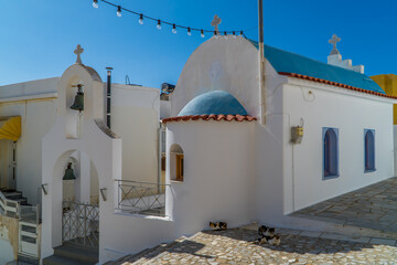 Small Cycladic white-blue orthodox church with cats in Ano Syros - Ermoupoli, Greece