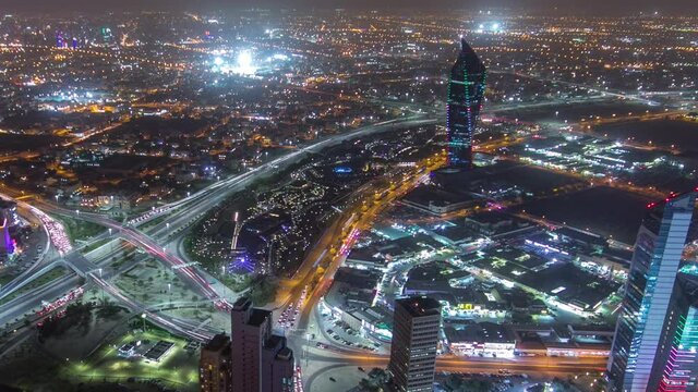 Skyline with Skyscrapers night timelapse in Kuwait City downtown illuminated at dusk. Aerial view from rooftop. Kuwait City, Middle East.