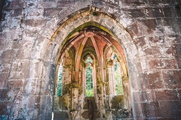 Part of the All Saints abbey ruins in the Black Forest near Oppenau, Germany on a sunny day. A statue of the Virgin Mary is in the center.