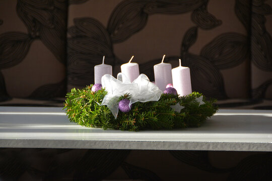 The Christmas wreath with white candles and purple ornament
