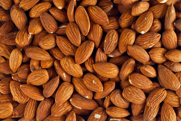Almonds close up. Texture of nuts. Lots of nuts in a pile.