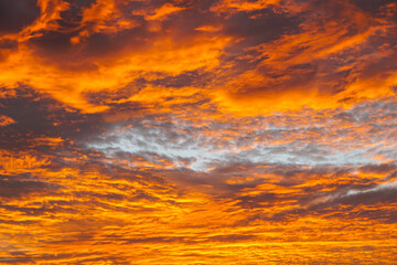 Abstract beautiful orange fluffy clouds on sunrise sky - colorful nature sky texture background