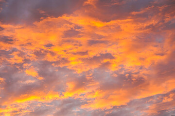 Abstract beautiful orange fluffy clouds on sunrise sky - colorful nature sky texture background
