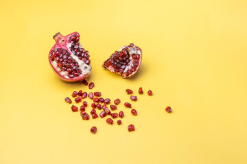 ripe broken pomegranate on a yellow background