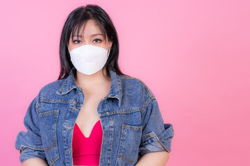 Asian girl wearing protective face mask for protection during the quarantine Coronavirus covid19 outbreak on yellow background , protect spread Covid-19