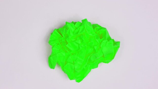 Stop motion animation paper wrinkles. Two color concept backdrop paper blank sheet making a paper ball folds and unfolds.