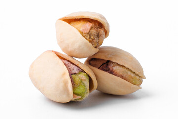 three salted pistachio nuts isolated on a white background
