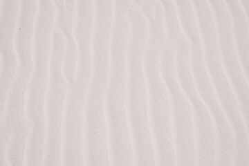 Fototapeta na wymiar Close up of vertical wavy sand layers at White Sands National Park in New Mexico, USA. Sand texture, sand background, sand wallpaper. 