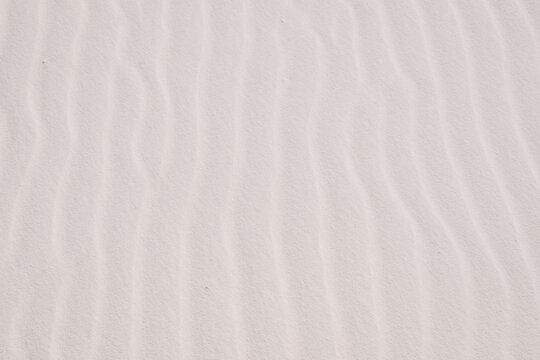 Close up of vertical wavy sand layers at White Sands National Park in New Mexico, USA. Sand texture, sand background, sand wallpaper.  