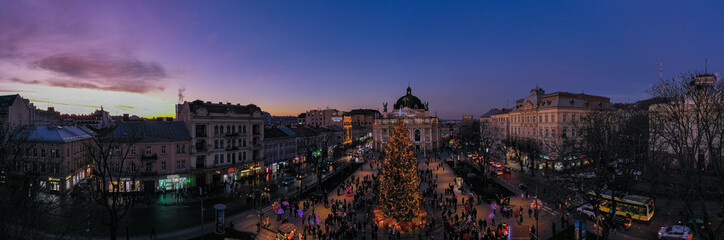 Fototapeta na wymiar Christmas tree near Opera House in Lviv, Ukraine. View from drone