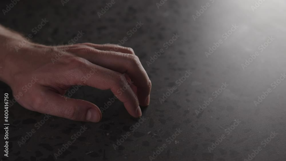 Canvas Prints Slow motion young man hand finger tap on terrazzo countertop with dim light