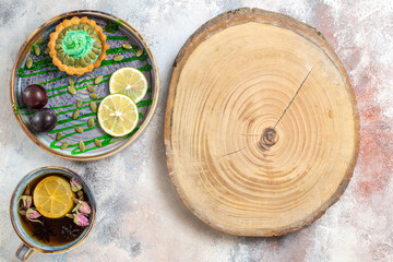 top view little cake with fruits and tea on light floor dessert biscuit sweet