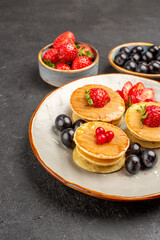 front view yummy pancakes little formed with fruits on grey background pie cake fruit