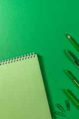 blank green notepad pen pencil