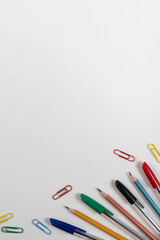 colored kardashi pens paper clips on a white background in the corner