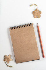 Brown notepad spiral wooden objects orange pencil