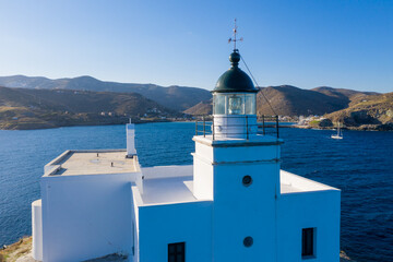 Greece, Kea Tzia island. Lighthouse on rocky cape, sky, sea background.