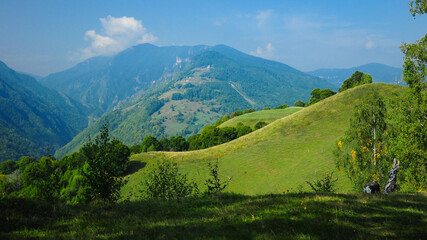 Sunny hills in Latoritei Mountains. This countryside landscape can be found near the Strategica road. A mountain path that crosses above al the massif's crests. Ciungetu, Carpathia, Romania.