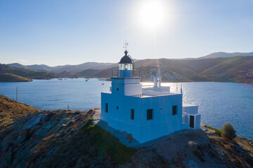 Fototapeta na wymiar Greece, Kea Tzia island. Lighthouse on rocky cape, sky, sea background.