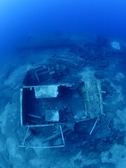 scuba divers exploring shipwreck scenery underwater ship wreck deep blue water ocean scenery of metal underwater