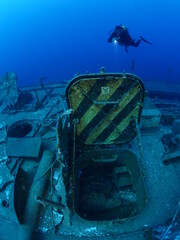 scuba divers exploring shipwreck scenery underwater ship wreck deep blue water ocean scenery of...