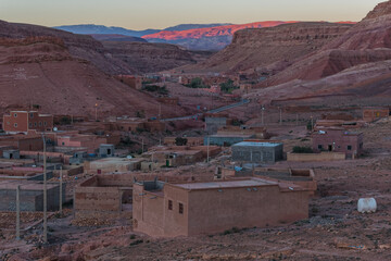 Village Tamedakhte with its oasis, in the background the snow covered summits of mountain Atlas