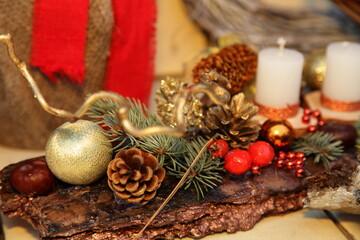 Beautiful colorful pine cones on blurred white candles backdrop christmas decoration art, Happy new year background close up