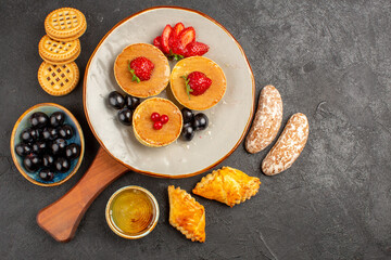 top view yummy pancakes with fruits and cakes on dark background fruit sweet cake