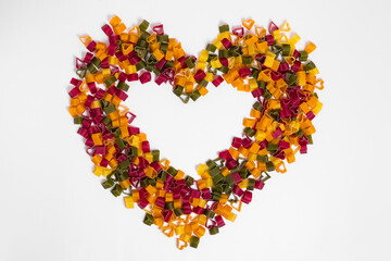 White background of italian colored pasta hearts . Original wallpaper of hearts of love for valentine's day.