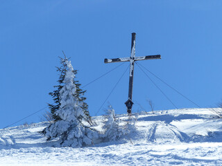 Summit cross of Setzberg mountain in wintertime, Tegernsee, Bavaria, Germany