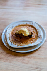 delicious plate of vanilla ice cream on toast and on a caramel cream coating the plate