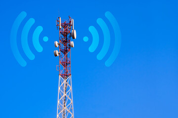 Cellular base station with transmitter antennas on a telecommunication tower on against a blue sky....