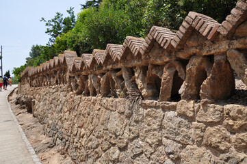 Fototapeta premium A beautiful stone fence along the pedestrian street. The fence is made of bricks.