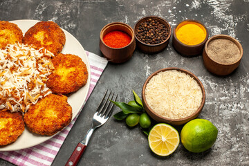 top view tasty fried cutlets with rice and seasonings on dark floor meat rissole food