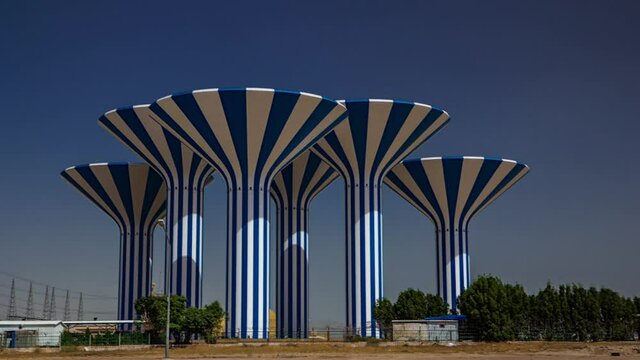 Blue and white water towers in Kuwait timelapse hyperlapse, Middle East. Blue sky and mosque on background