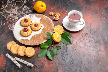 top view yummy little cookies with fruits on dark desk sugar cake sweet biscuit
