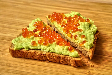 Red caviar and avocado sandwich for a healthy snack. Proper nutrition. Delicious and healthy food.