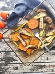 Roasted sweet potatoes and aubergines in a wood table