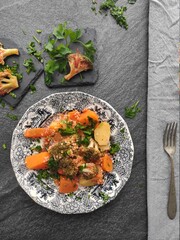 Sweet potatoes and broccoli couscous in  tomatoes sauce a rich handful of persil and coriander.  stilish with orange, grey and green playful background effect. 