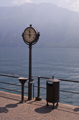 clock on a pier near the lake of Garda