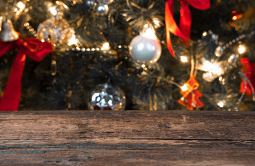 Blurry Christmas background with Christmas tree and lights. Side view with space to copy.