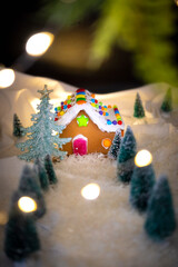 Gingerbread House Village under the twinkling star lights, Bokeh, dark night with warm light