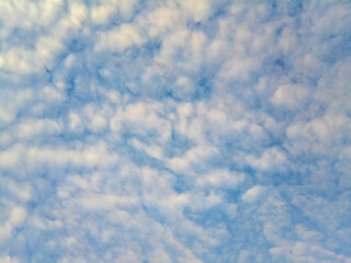 Natural blue sky background with beautiful puffy white clouds