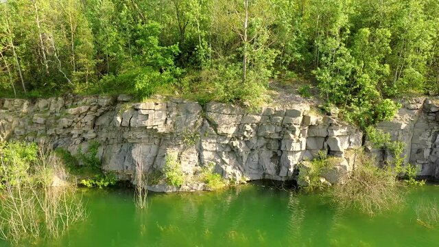 Aerial view of a beautiful lake at the site of a former quarry. Beautiful landscapes of wild nature with a lake with high banks of stone. Beautiful landscape.