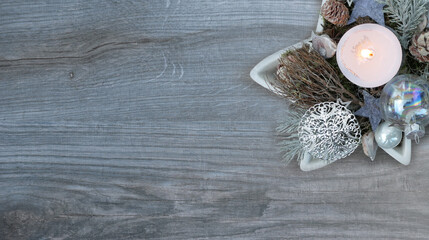 elegant christmas decoration with burning candle on wooden background upper right corner  - copy space