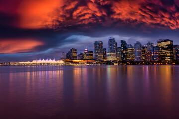 Fototapeta na wymiar View of Coal Harbour in Downtown Vancouver, British Columbia, Canada, after Sunset. Modern City Skyline during Night. Dramatic Sky Artistic Render