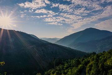 Sun rising in Smolikas mountain. View of surrounding forest and summits from Pades village.