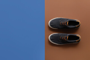 Casual male shoes on color background