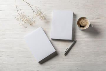 Composition with blank books on wooden table